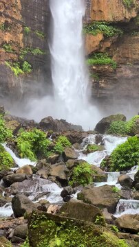 Koban Kapas Biru is a waterfall in the tropical jungles of East Java, descending from a high cliff into a lush green canyon surrounded by tropical forests with vibrant vegetation.Lumajang River. 4К