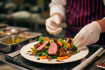 Exquisite Steak Dish Plated by Chef in Modern Restaurant Kitchen, Ready to Delight Guests with Culinary Artistry