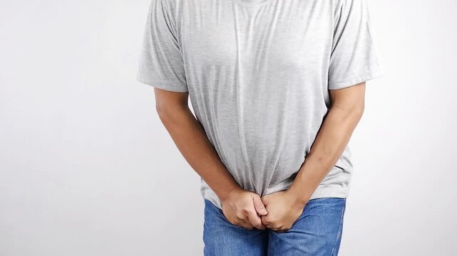 Urinary incontinence, man holding crotch, urgent need to urinate, health problems, cystitis.Erectile dysfunction concept. Men's health. Man holding genitals.Men's health, venereologist, sexual disease