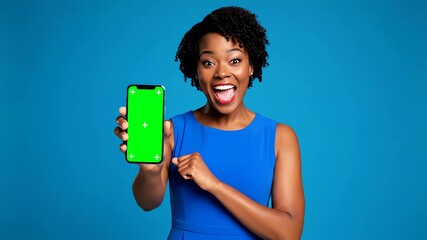 Enthusiastic woman proudly presents a vivid green screen Phone Mockup, ideal for your dynamic advertising campaigns and app promotions
