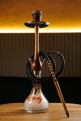 Enjoying a hookah session with a beautifully crafted water pipe and flavorful tobacco at a lounge...
