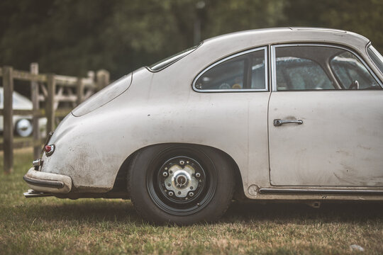 Classic sports car Coupe parked on grass with a vintage aesthetic