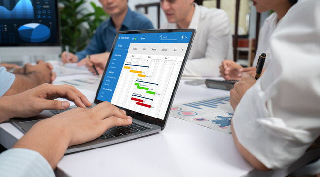 Project planning software for brisk business project management on the computer screen showing timeline chart of the team project