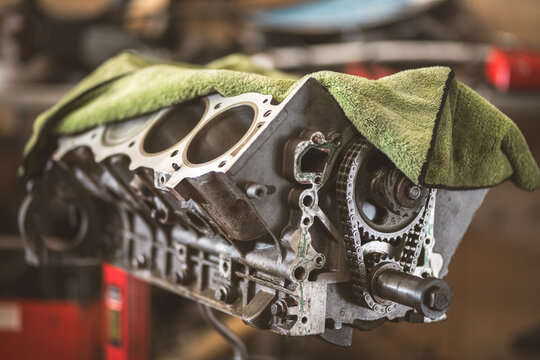 Close-up of a disassembled engine block with timing chain and gears