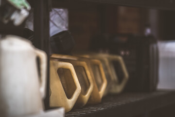 Row of oil containers on a shelf in a garage, workshop, or auto repair shop