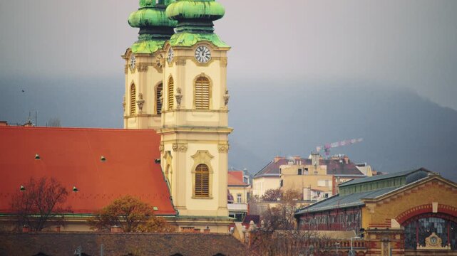 Historic clock tower rising above city buildings, highlighting timekeeping and architecture