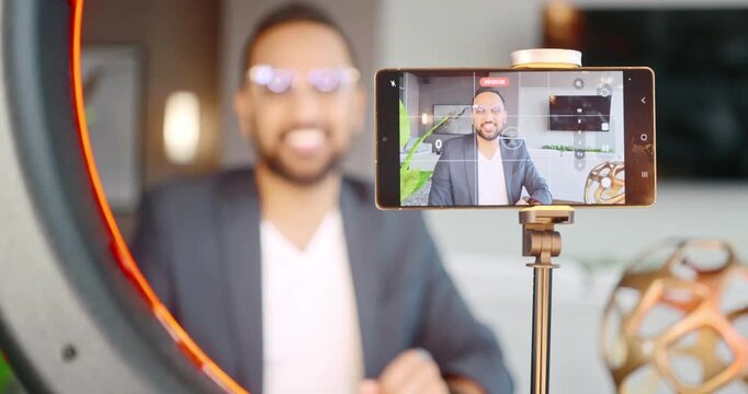 Man filming vlog with smartphone and ring light