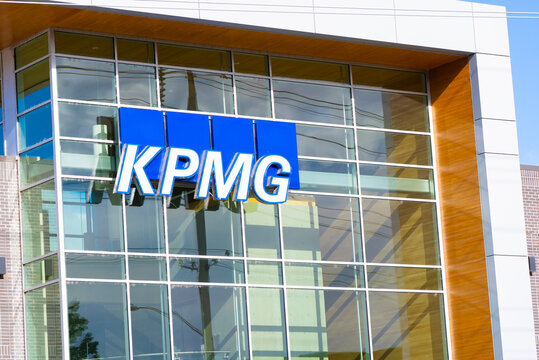 KPMG professional services signage on a modern building during daytime