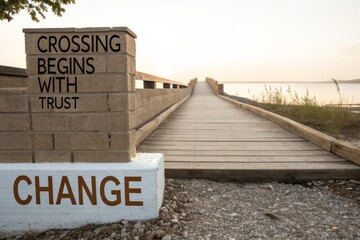 Wooden boardwalk leading to the ocean at sunset, with a brick pillar bearing a message of change