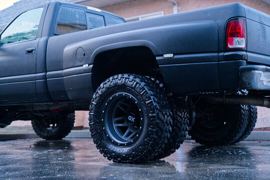 Black 1996 Dodge Ram 3500 dually with big tires still wet from being recently washed