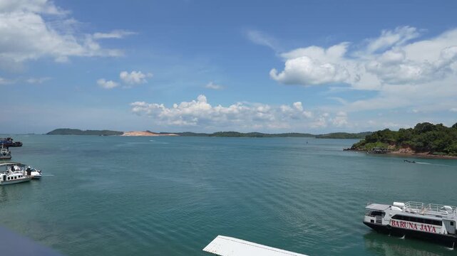 B roll of Oceanna Baruna Jaya ferry sailing between Tanjung Balai Karimun and Batam showing passenger transport across calm sea with coastal views and daily island connectivity