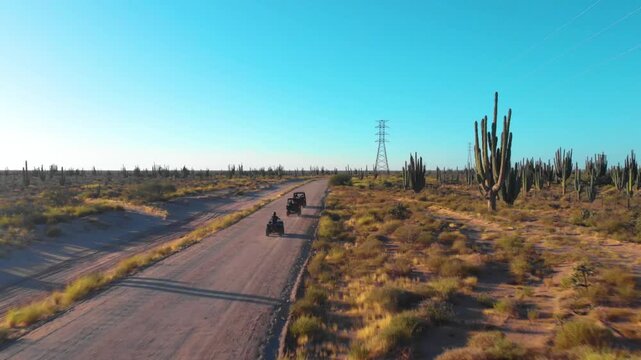 toma aerea con dron de rangers y cuatrimotos cruzando el desierto lleno de cactus en el desiero de Sonora