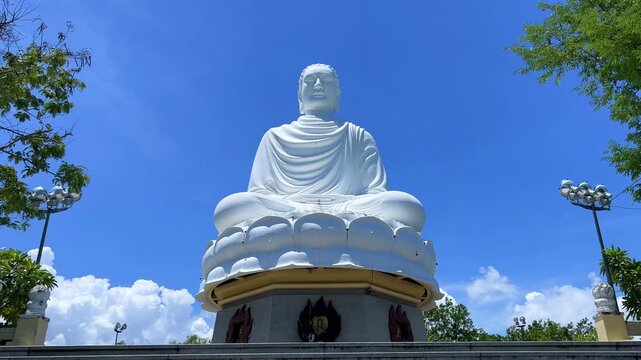 Nha Trang, Vietnam - September 18, 2025. Chua Long Son Pagoda with a large white Buddha statue in the vast, clear blue sky. The main Buddhist temple of Kien Giang Province. 4К