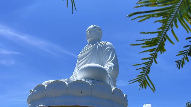 Nha Trang, Vietnam - September 18, 2025. Chua Long Son Pagoda with a large white Buddha statue in the vast, clear blue sky. The main Buddhist temple of Kien Giang Province. 4К