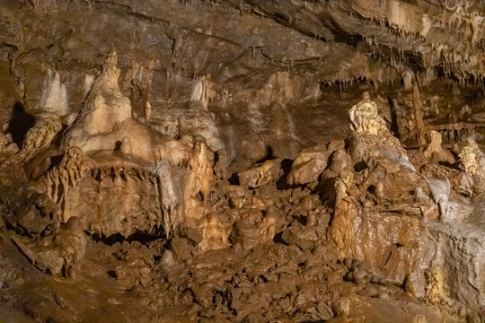 Punkva Cave interior in the Moravian Karst with limestone chambers, stalactites, stalagmites, and an underground river. Karst geology environment showing rock formations, subterranean landscape