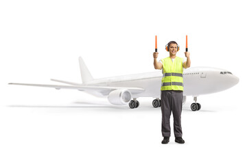 Aircraft marshaller signalling with wands in front of a plane