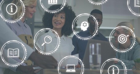 Discussing, team of four in business attire reviewing laptop and papers in office with UI icons