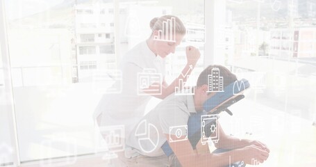 Pressing therapist white top pressing client's back on blue face cradle chair in spa with overlays