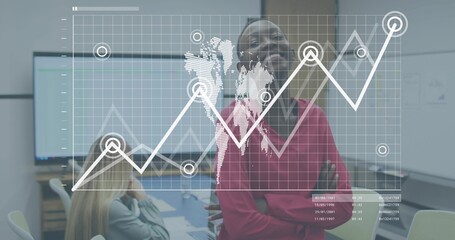 Standing colleague in red sweater presenting data overlay with world map in boardroom with monitors