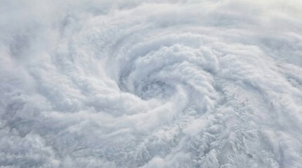 Satellite View of Massive Tropical Cyclone with Powerful White Cloud Spirals and Defined Central Eye Forming Intense Weather Pattern From