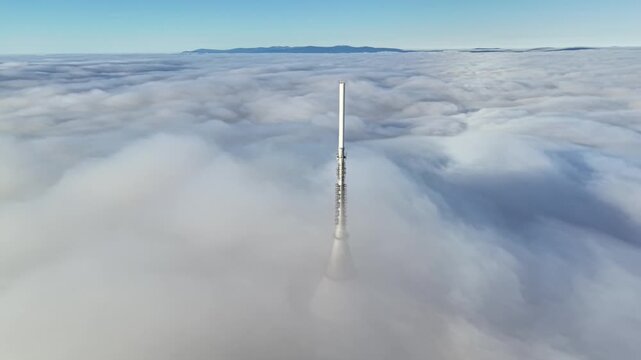 Tower Tip Rising Above Dense Cloud Cover, Metallic Spire Cutting Through Smooth Cloud Layer, Minimal