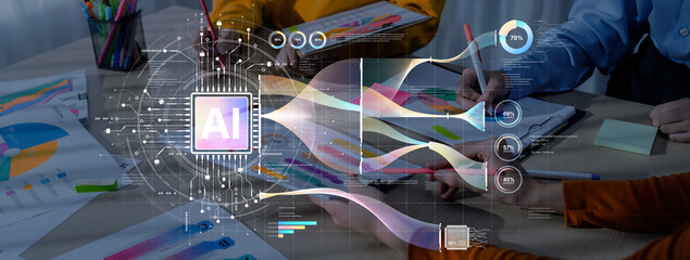 A team collaborates in a modern office setting, utilizing artificial intelligence tools and digital graphics to enhance productivity and creativity in their projects. Trope