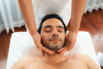 Caucasian man enjoying relaxing anti-stress head massage and pampering facial beauty skin...