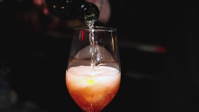 Bartender working, beautiful row line of different coloured liquor alcohol cocktails on a party in a bar, catering banquet on event, barman mixing drinks, selection of beverages in a restaurant club