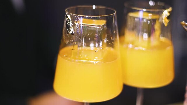 Bartender working, beautiful row line of different coloured liquor alcohol cocktails on a party in a bar, catering banquet on event, barman mixing drinks, selection of beverages in a restaurant club