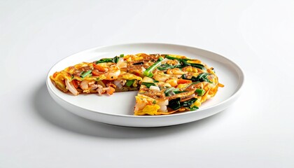 A delicious, freshly cooked frittata with spinach and other vegetables, served on a white plate with a slice removed.