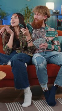 Planning family budget. Smiling family married couple man woman counting money cash, use smartphone calculate domestic bills at home. Husband wife satisfied of income for planned vacation, gifts
