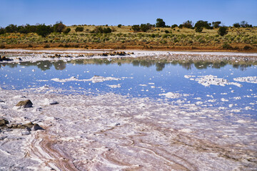 Salt lake with blue water and mineral crust Stuart Highway Oakden Hills South Australia