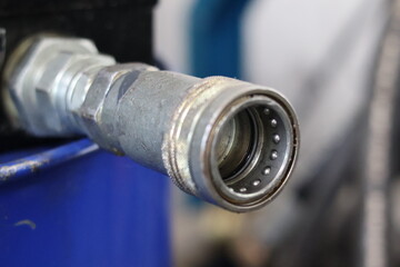 Close up of a professional metal quick coupling socket for hydraulic or pneumatic systems,...