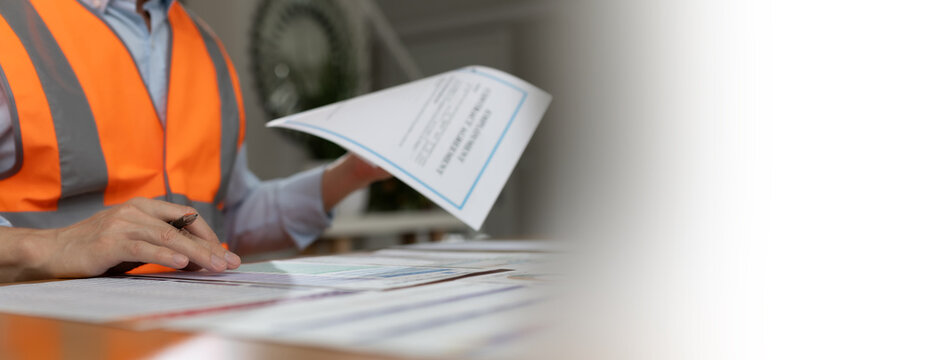 Business professional reviewing and signing financial documents with pen on desk. Corporate paperwork, audit process, accounting review, compliance, administration, and professional business workflow 