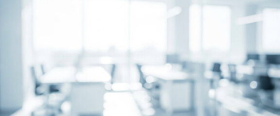 Bright and modern office space features blurred furniture and large windows allowing natural light to flood in, creating an open and airy atmosphere conducive to productivity.