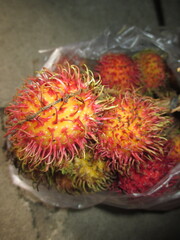 sweet and fresh rambutan fruit in a plastic container to enjoy