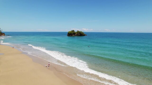 Aerial view of wide sandy beach Playa Cocles in Costa Rica on bright sunny day
