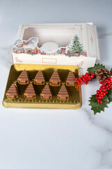 Small milk chocolate bars shaped like Christmas trees_vertical.