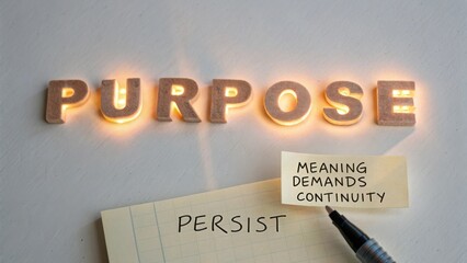 Illuminated Wood Letters Spell Purpose with Sticky Note Messages on a Notepad Symbolizing Life Goals and Determination