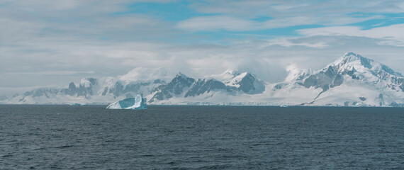 Epic Wide View of Antarctica Peninsula with Floating Iceberg Across Ocean View From Ship. Scenic...
