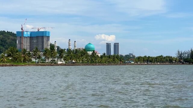Malaysia, June 31, 2025: The Masjid Bandaraya City Mosque in Kota Kinabalu, Sabah. View of the floating mosque from Likas Bay Beach on the South China Sea. 4K