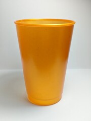 orange plastic cup on white background