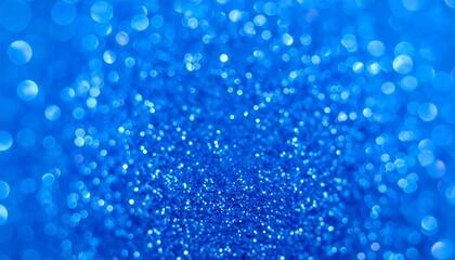 Close-up of sparkling blue glitter, creating a dazzling, blurred bokeh effect of light reflecting across the surface