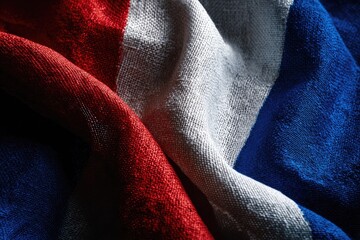 Woven fabric with red, white, and blue stripes, artfully draped and shadowed