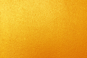 Gold or yellow paint on cement wall texture  background.