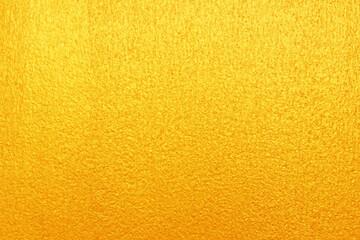 Gold or yellow paint on cement wall texture  background.