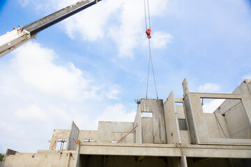 Background banner. Large cranes moving prefabricated walls in factories. Prefabricated concrete walls for building office buildings and residential houses. reinforced concrete wall