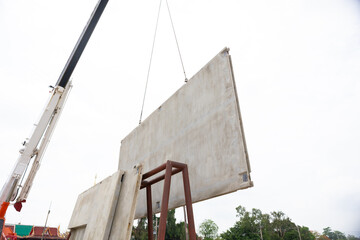 Background banner. Large cranes moving prefabricated walls in factories. Prefabricated concrete walls for building office buildings and residential houses. reinforced concrete wall