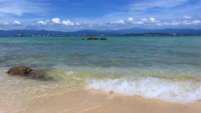 Landscapes of Manukan Island, part of the Tunku Abdul Rahman National Park in Sabah, Malaysia. Kota Kinabalu. Soft white sand. Clear turquoise water. The beach is surrounded by dense jungles. 4К