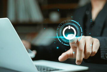 Man using laptop with pressing power button on virtual screen. Start or shut down concept. news on